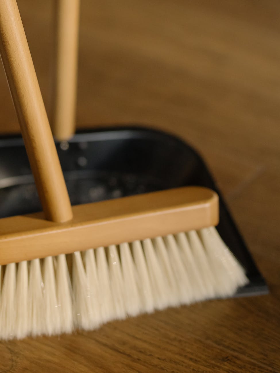 brown wooden brush on black plastic container